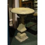 A STONE BIRD BATH, standing on a plinth / column support, circular bath, 37" tall approx