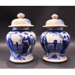A PAIR OF BLUE & WHITE MINIATURE GINGER JARS, crackle glazed, each with images of figures in