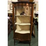 A TALL CURVED GLAZED DISPLAY CABINET, with a single door, lined shelved interior, decorated with