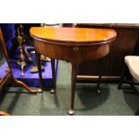 A FINE DEMI - LUNE SHAPED FOLD OVER TEA TABLE, raised on 4 legs, 1 gate leg, all with pad feet,