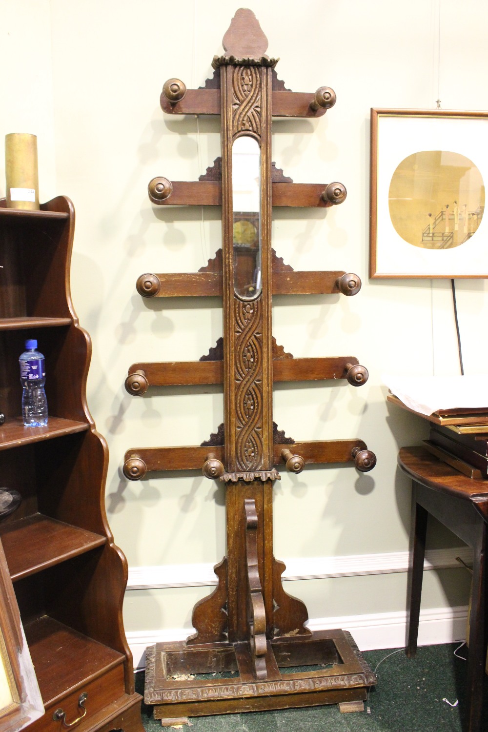 A 'TREE OF LIFE' COAT RACK, oak, with mirror to the centre, 10 branches, each with turned coat hook,