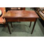 A FINE MAHOGANY FOLD OVER TEA TABLE, on square leg, with fluted canted corners, on a gate leg when