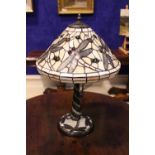 A TIFFANY STYLE TABLE LAMP, with dragon fly shade in cream colours, with two toned graduating column