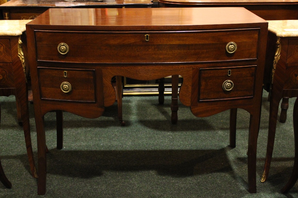 A LATE 19TH CENTURY MAHOGANY BOW FRONTED 3 DRAWER SIDE TABLE, on down swept feet, 19" x 36" x 29"