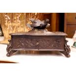 A CARVED "BLACK FOREST" STYLE WOODEN TRINKET / JEWELLERY BOX, with carved detail all over, the lid
