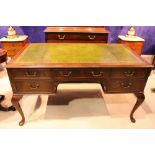A LARGE LEATHER TOPPED WRITING DESK, with 5 drawers, raised on a Queen Anne leg, with pad foot,