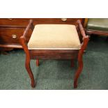 A LIFT TOP PIANO STOOL, raised on shaped legs, hinged lid, 19" x 14" x 23" approx