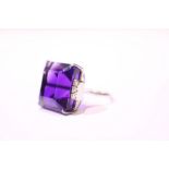 A WHITE GOLD & DIAMOND & AMETHYST RING, with very large central amethyst stone with 6 diamonds to