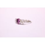 AN 18CT WHITE GOLD 3 STONE DIAMOND & SAPPHIRE RING, with a central pink sapphire flanked by a