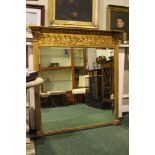 A LARGE REGENCY STYLE GILT OVER MANTLE MIRROR, with a single bevelled panel of glass, decorated to
