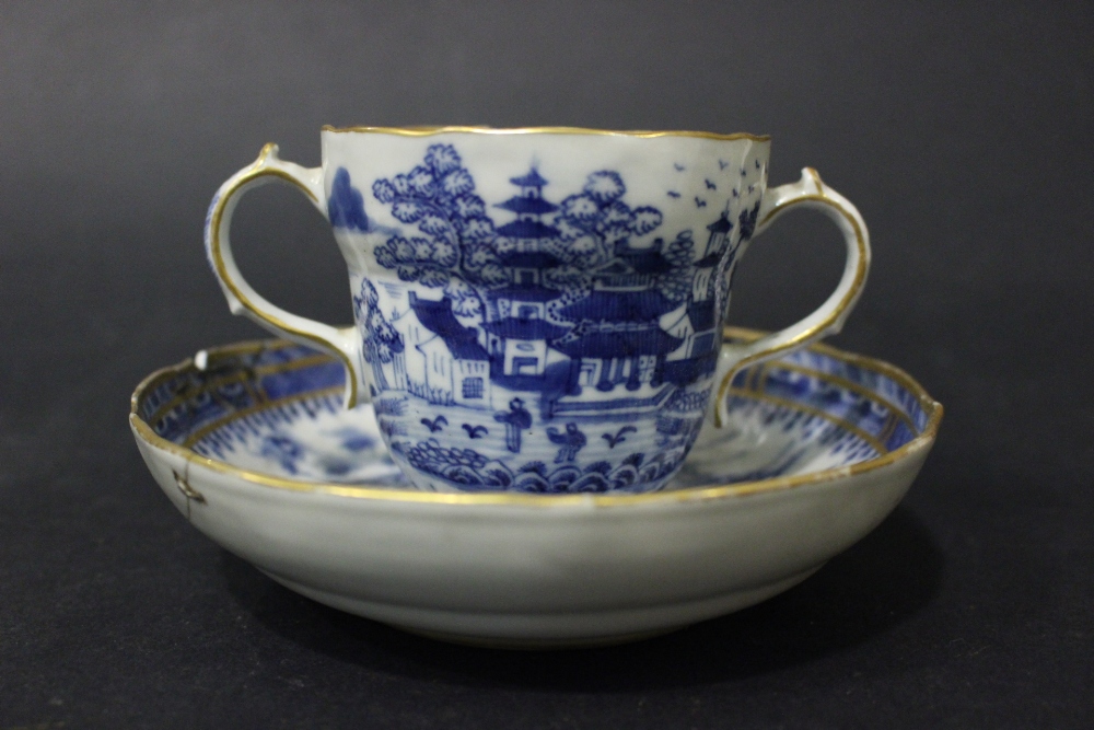 A 19TH CENTURY TWO HANDLED 'CHOCOLATE' CUP & SAUCER, with deep saucer, having detailed imagery of