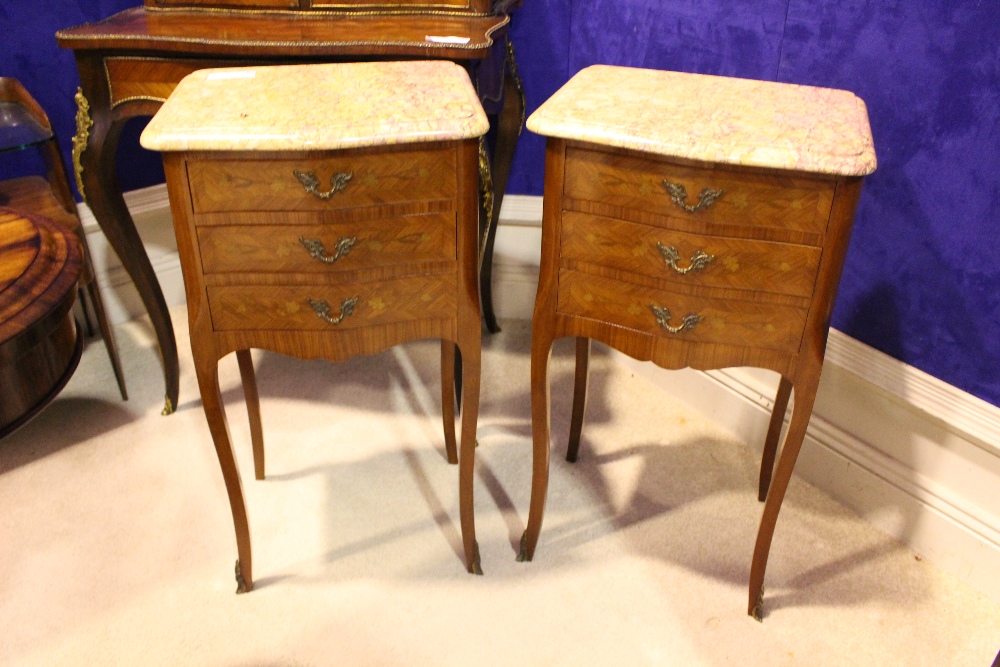 A PAIR OF MARBLE TOPPED CABINETS, three drawers, with crossbanded drawers & brass handles and toe