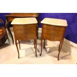 A PAIR OF MARBLE TOPPED CABINETS, three drawers, with crossbanded drawers & brass handles and toe