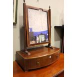 A FINE TABLE TOP SWING MIRROR, with a bow fronted base drawer, string inlaid edge to the mirror,