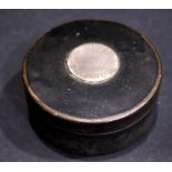 A SCOTTISH SNUFF BOX, lacquered, paper maché with a silver circular disc to the lid, 3.5" diam,