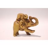 A CARVED NETSUKE OF AN ELEPHANT with a rodent seated on its back, 2" x 1.5" x 1" approx