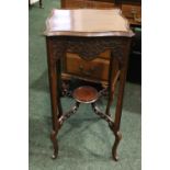 A MAHOGANY PLANT STAND, with blind fretwork detail to the shaped frieze, raised on four legs, united