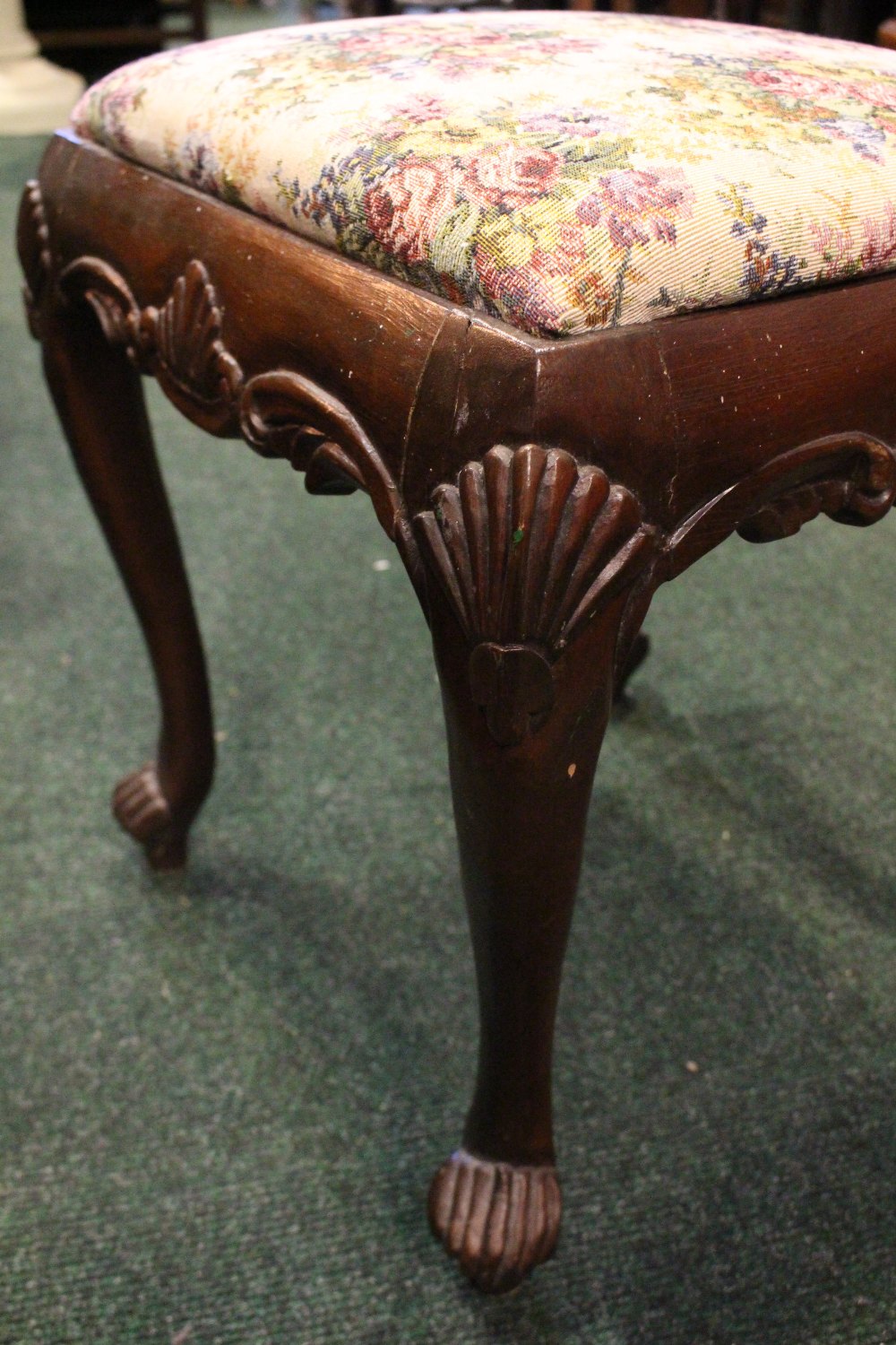 AN IRISH 19TH CENTURY CARVED FOOTSTOOL, with shell motif to the knees and apron, having a stuffed - Image 3 of 3