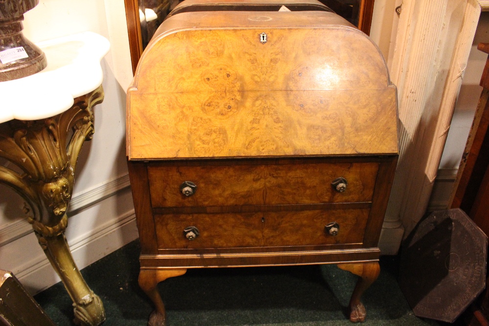 AN ART DECO WALNUT FALL FRONT WRITING BUREAU, with two drawers, raised on cabriole leg