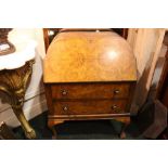 AN ART DECO WALNUT FALL FRONT WRITING BUREAU, with two drawers, raised on cabriole leg