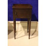 A GEORGIAN MAHOGANY CABINET, with a single door, raised on turned legs, with a raised gallery