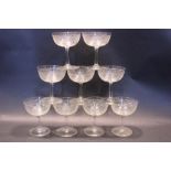 SET OF 9 CHAMPAGNE COUPES, each with a band of floral decoration to the bowl