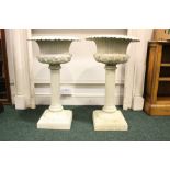 À PAIR OF GARDEN URNS, raised on tall columns, 32" tall, 19" diam of urn