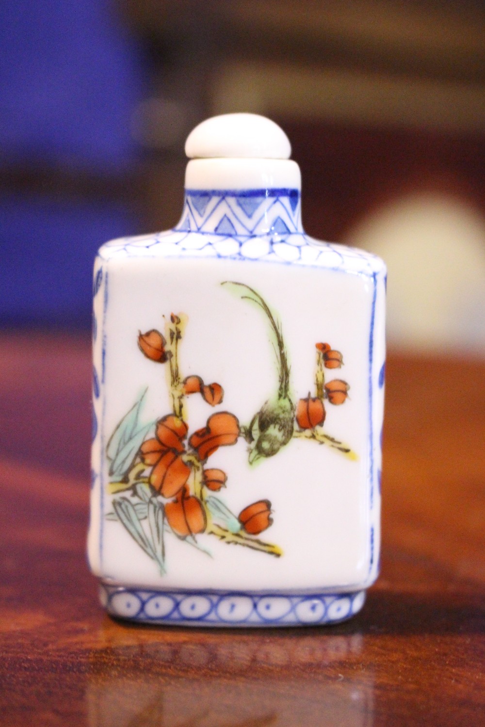 A CHINESE PORCELAIN SNUFF BOTTLE, with images of flowering tree and birds, having four character