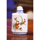 A CHINESE PORCELAIN SNUFF BOTTLE, with images of flowering tree and birds, having four character