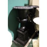 A PAIR OF CAST IRON GARDEN URNS, standing on plinth bases