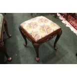 AN IRISH 19TH CENTURY CARVED FOOTSTOOL, with shell motif to the knees and apron, having a stuffed