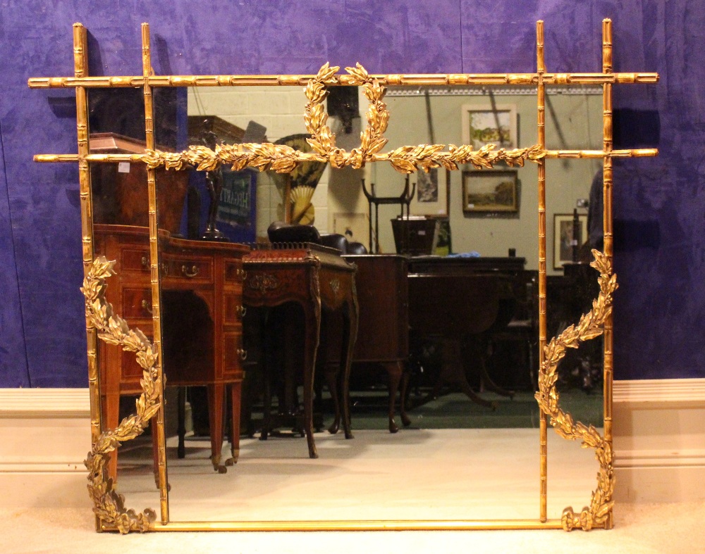 A GILT WOOD OVER MANTLE MIRROR, with bamboo style frame, having foliage decoration, 64" x 47"