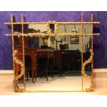 A GILT WOOD OVER MANTLE MIRROR, with bamboo style frame, having foliage decoration, 64" x 47"