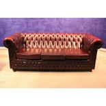 A VERY FINE 3 SEATER 'CHESTERFIELD' COUCH, with button back and curved armrests, 77" long, 34"