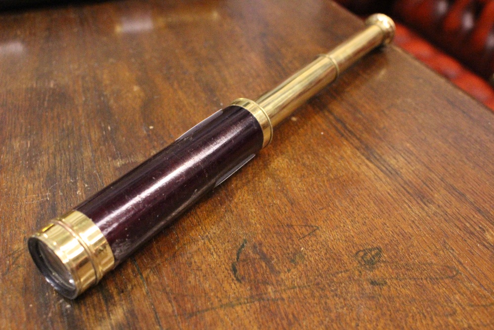 A SMALL TELESCOPE WITH WOODEN BODY, comes in a small leather pouch