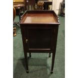 AN EARLY 20TH CENTURY CABINET, with a single door, having brass pull handle, raised on tapered spade