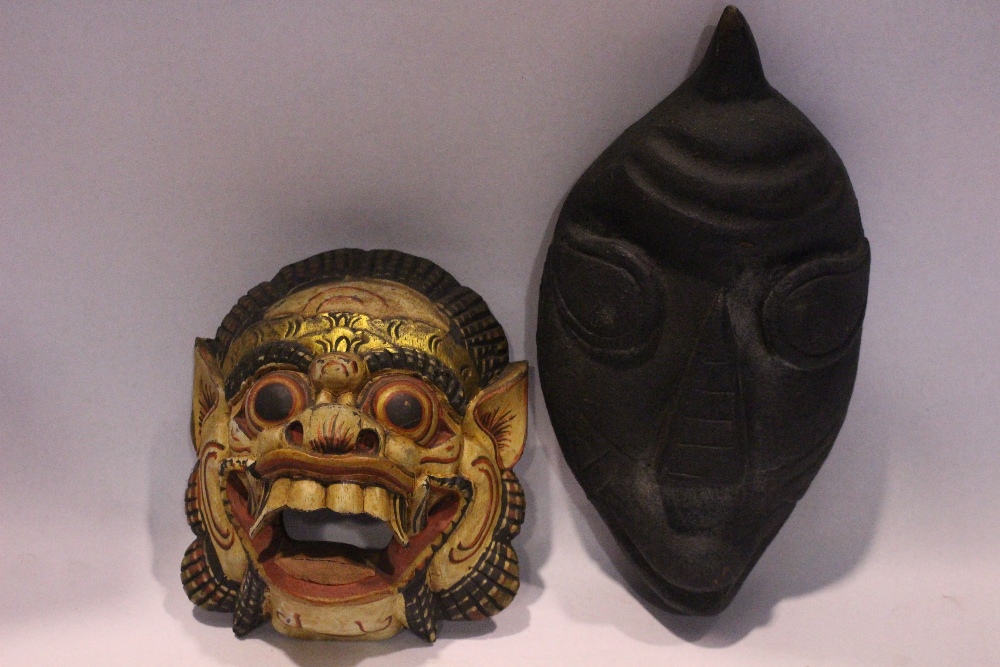 TWO CARVED 'TRIBAL' MASKS, (i) An open mouthed lion, colourful mask, 8" x 7" x 3.5" approx (ii) An