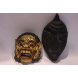 TWO CARVED 'TRIBAL' MASKS, (i) An open mouthed lion, colourful mask, 8" x 7" x 3.5" approx (ii) An