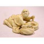 A LATE 19TH CENTURY NETSUKE OF A MAN, stirring the contents of pot, with a rodent on a seated on a