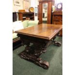 A VERY LARGE OAK CARVED 19TH CENTURY TRESTLE TABLE, with carved lion head canted corners, raised