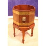 A REGENCY STYLE BRASS BOUND WINE COOLER / STAND, with lift away octagonal box, raised on tapered
