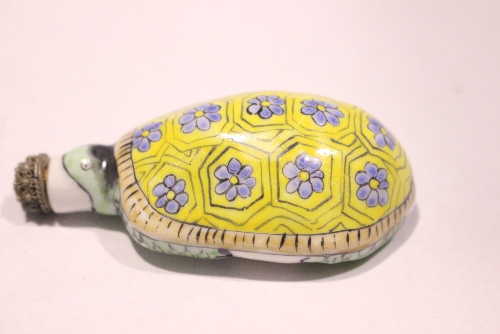 A PORCELAIN SNUFF BOTTLE, in the form of a turtle, with floral decoration to its back, a stopper