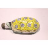 A PORCELAIN SNUFF BOTTLE, in the form of a turtle, with floral decoration to its back, a stopper