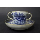 A 19TH CENTURY TWO HANDLED 'CHOCOLATE' CUP & SAUCER, with deep saucer, having detailed imagery of