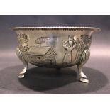 AN IRISH SILVER SUGAR BOWL, decorated with farming life scenes, a gadrooned out turned rim,