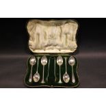 A SET OF 4 SILVER TEA SPOONS WITH A SUGAR TONGS, in original case, with an unmatched pair of other