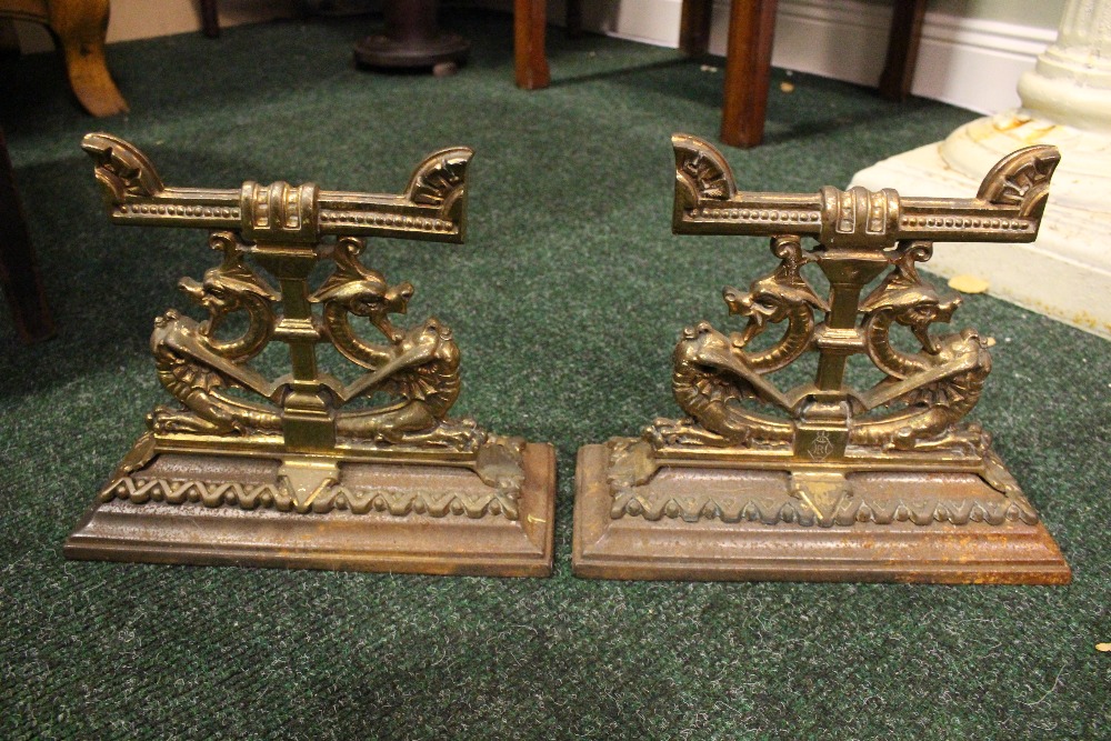 A PAIR OF LATE 19TH CENTURY FIRE DOGS, in the form of two pairs of open mouthed dragons, each with