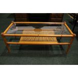A 'BAMBOO' STYLE COFFEE TABLE, two tier, top glazed surface over a cane rattan style tier below, 48"