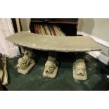A STONE GARDEN BENCH / SEAT, curved seat, sitting on three supports in the form of dolphins, 19" x