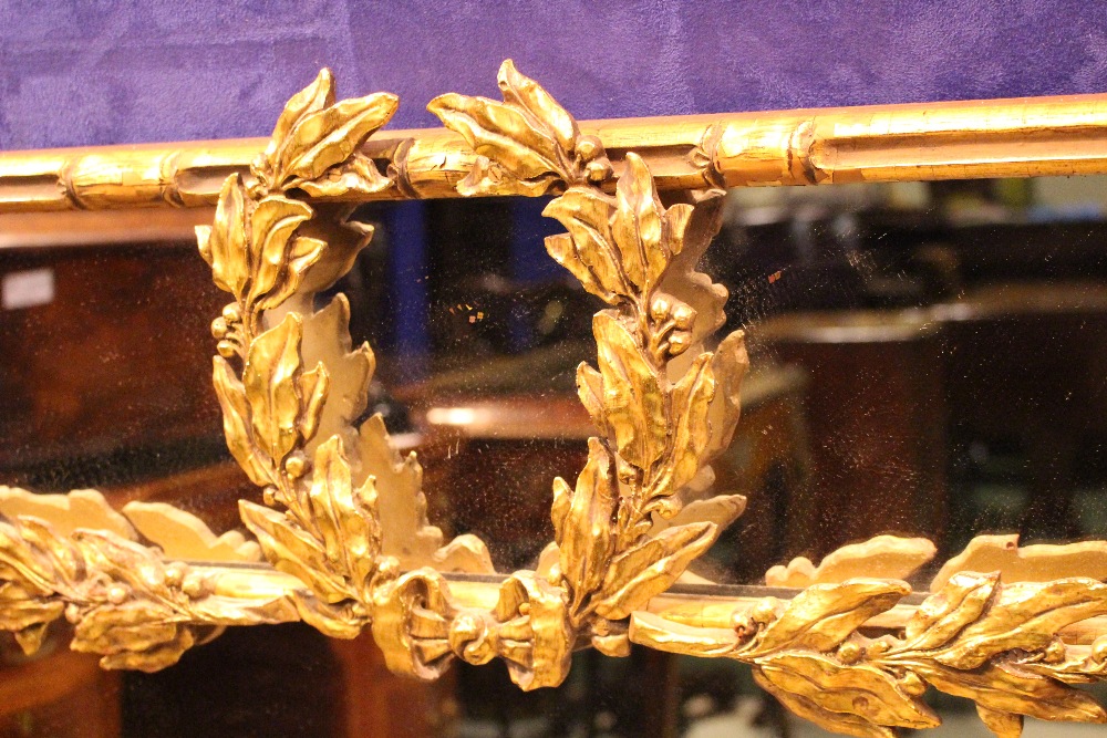 A GILT WOOD OVER MANTLE MIRROR, with bamboo style frame, having foliage decoration, 64" x 47" - Image 2 of 3